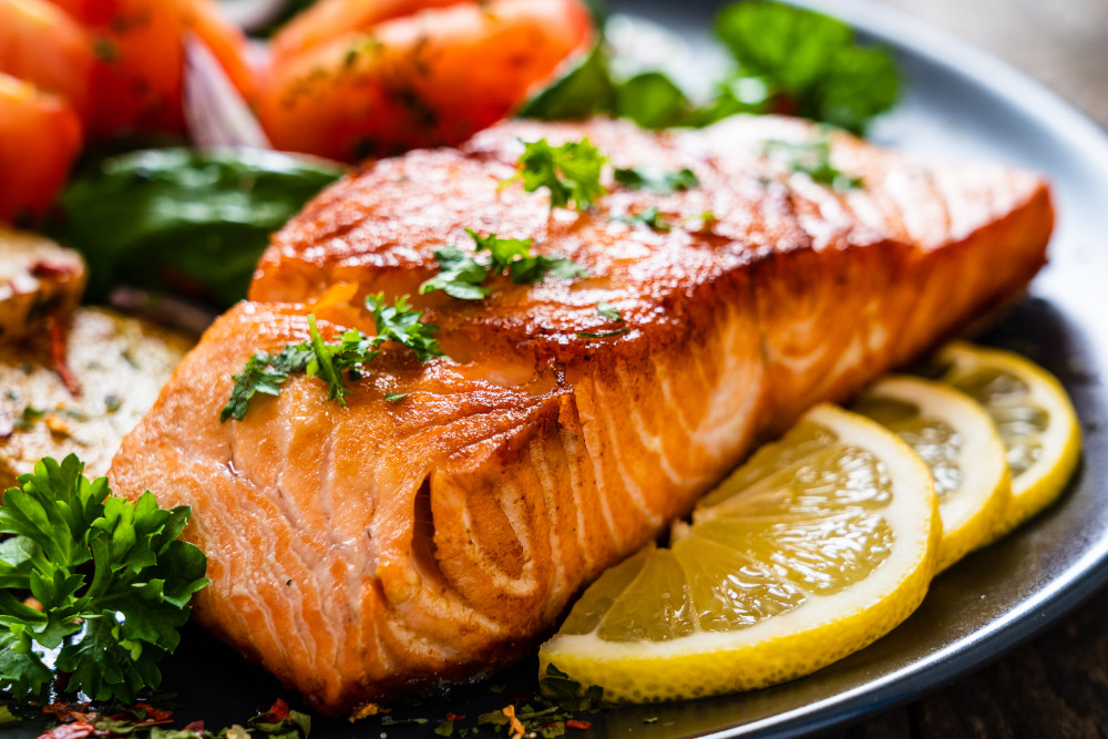 A salmon steak served with lemon slices