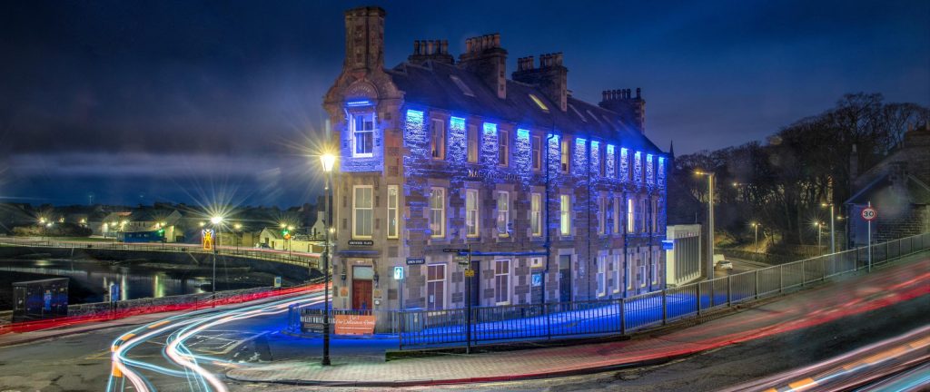 Mackays Hotel referenced in the treasure island in Wick lit up at night