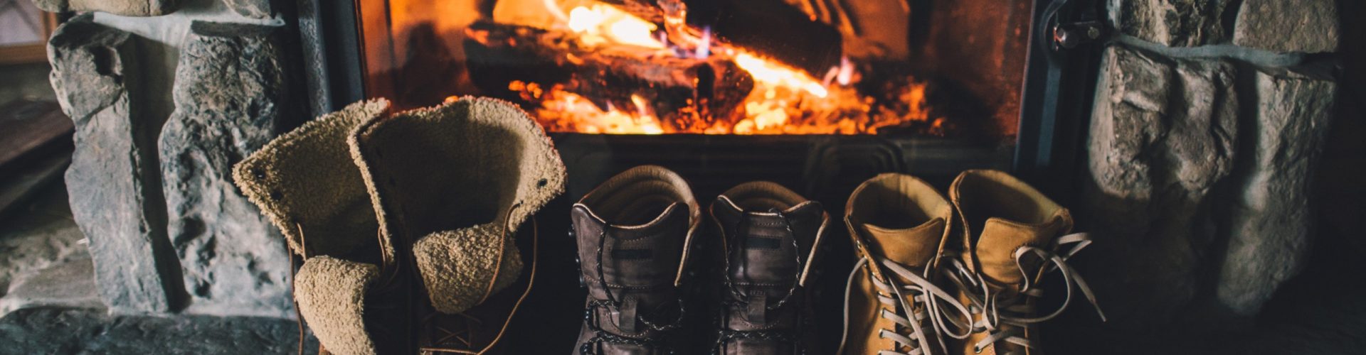 Winter boots warming by the fire