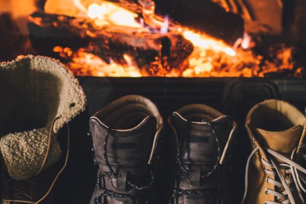 Winter boots warming by the fire