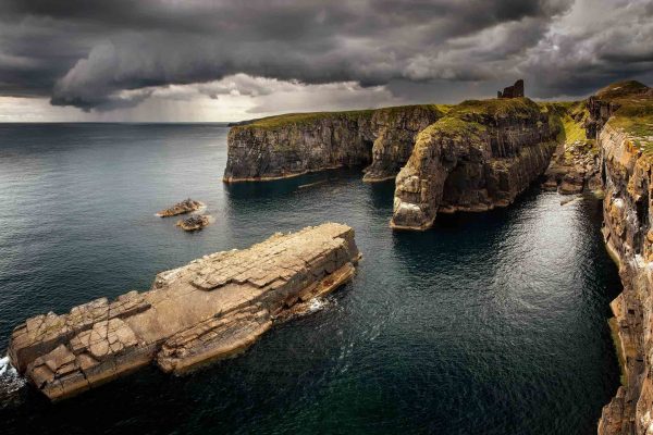 Wick Castle on the cliffs overlooking the sea