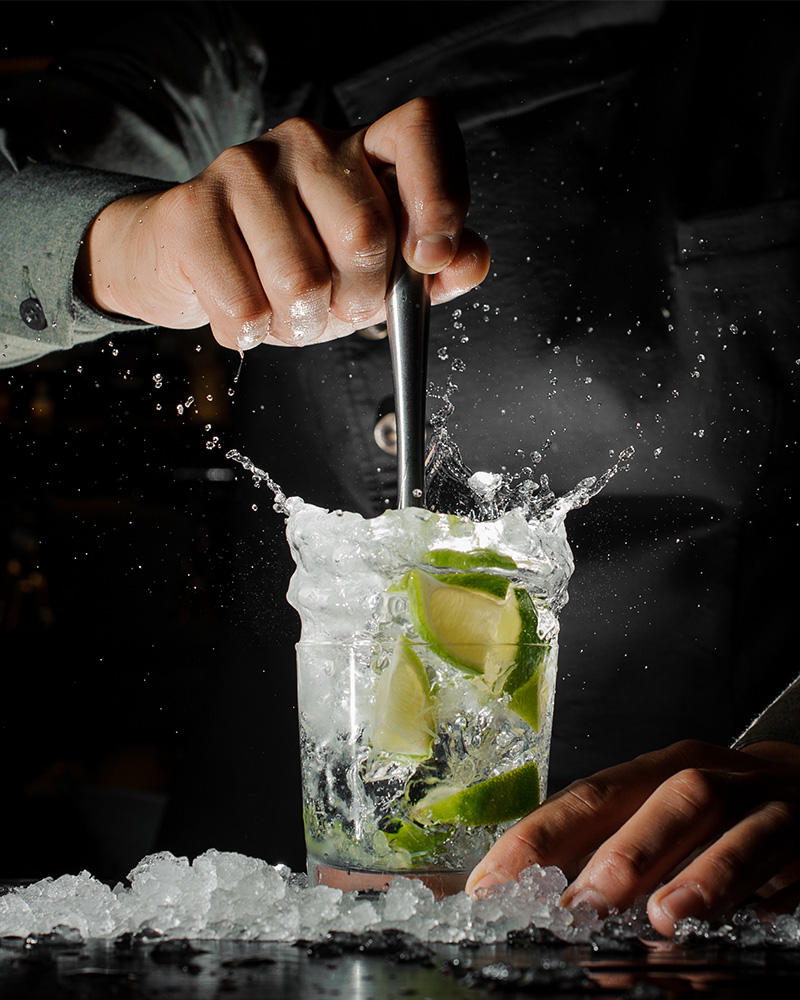 A barman making a Caipirinha cocktail