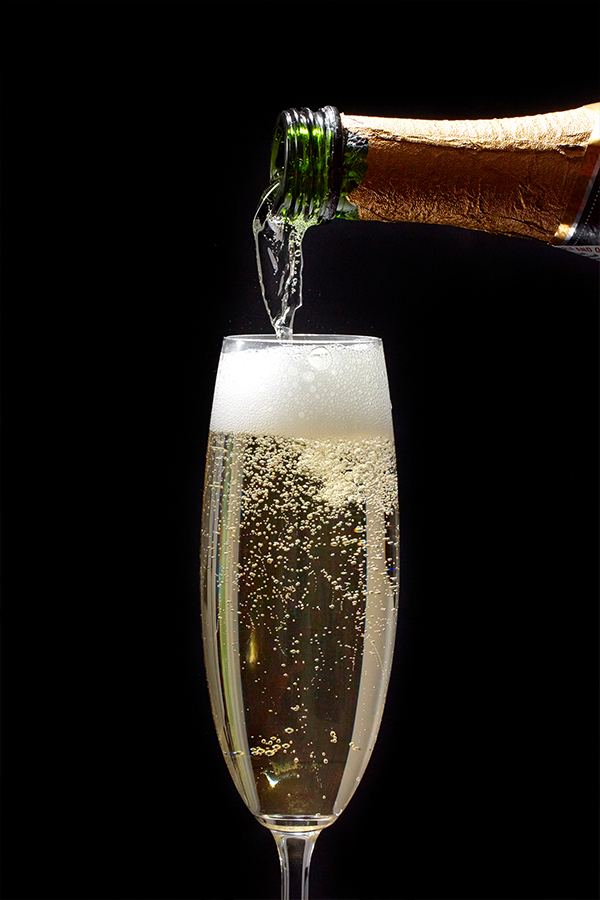 A glass of champagne being poured