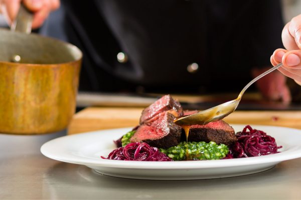 A chef serving up a plate of food