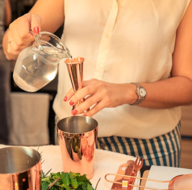 A lady on a cocktail making class