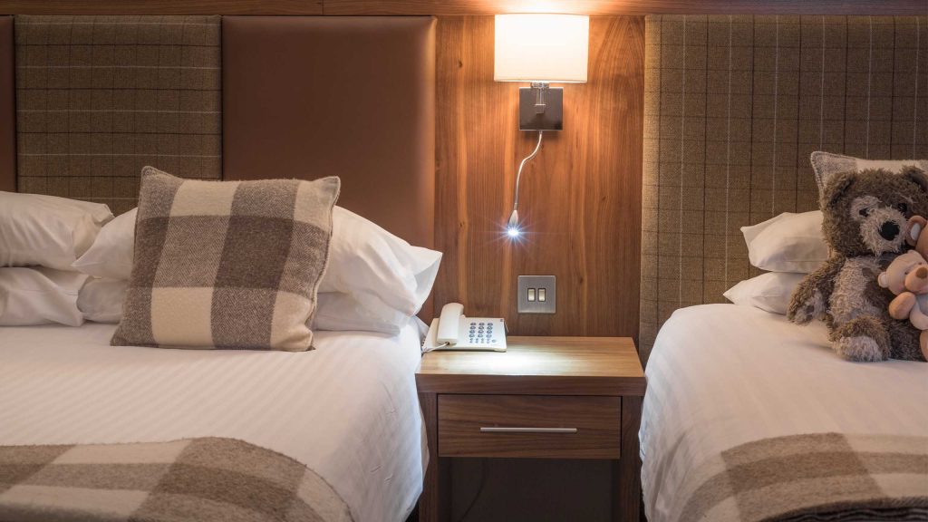 Beds in a Family Room with teddies on the single bed in Mackays Hotel in Wick