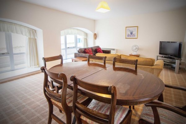 A dining and living room in a Mackays Hotel Self Catering Townhouse