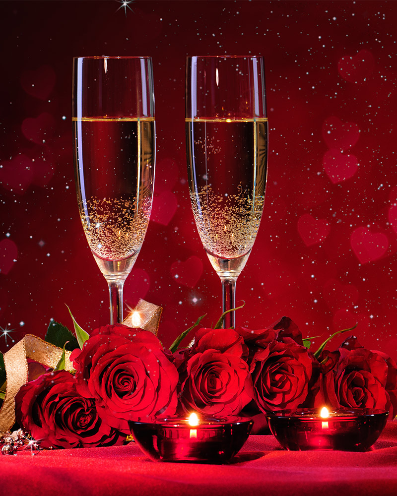 Two glasses of champagne and red roses