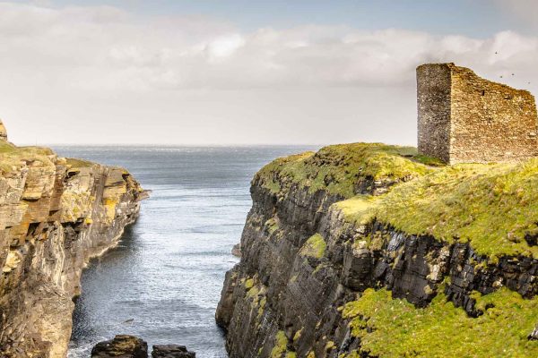 The ruins of Wick Castle on the cliffs overlooking the sea