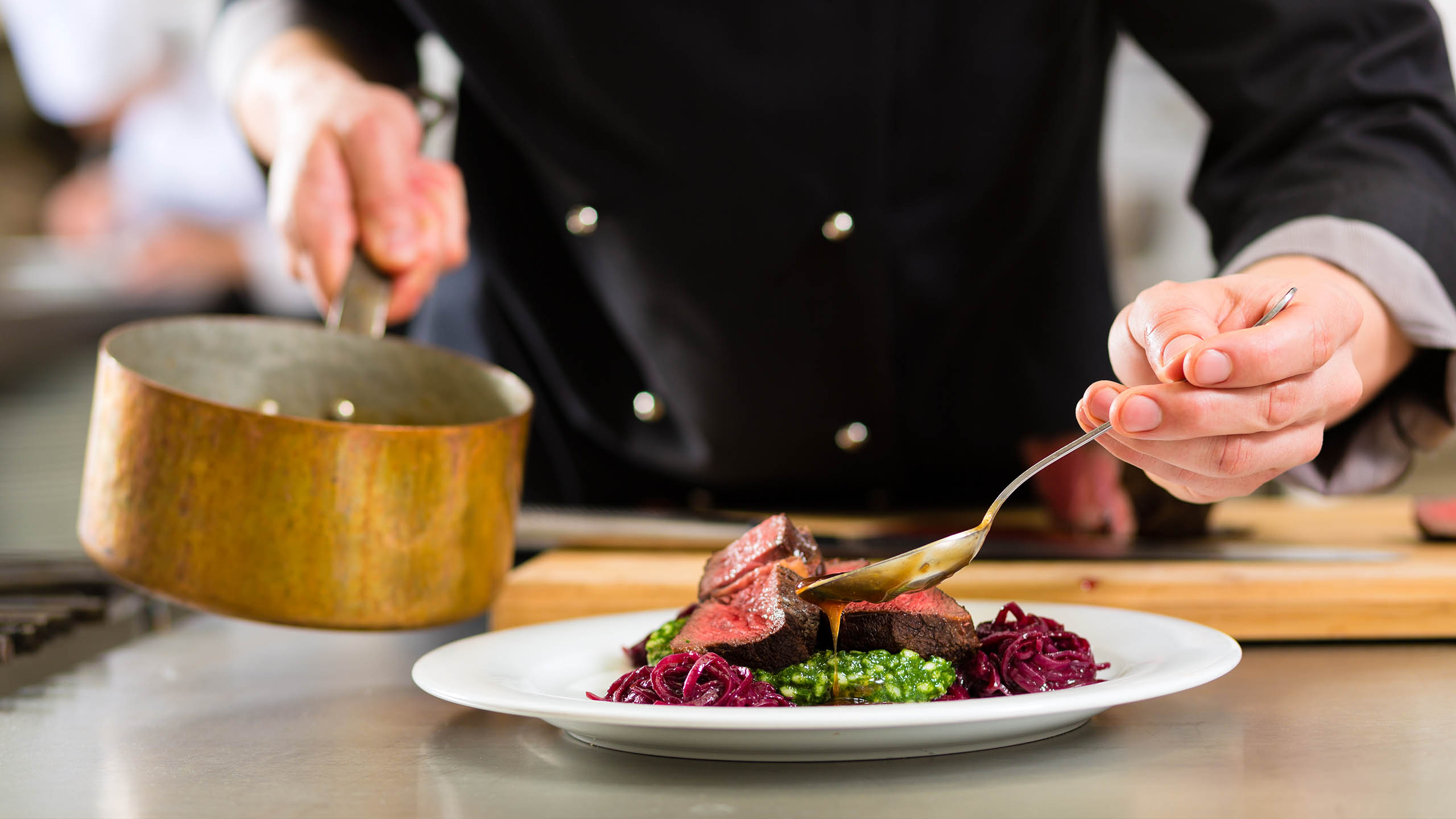 A chef serving up a plate of delicious food