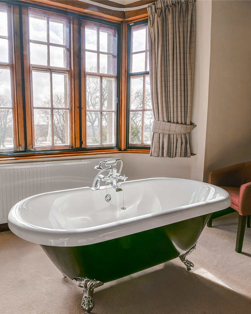 A roll top bath in a bay window in Langhills self catering belonging to Mackays Hotel in Wick