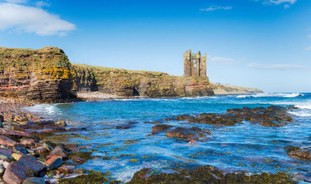 Old Wick Castle set on the cliffs on a sunny day