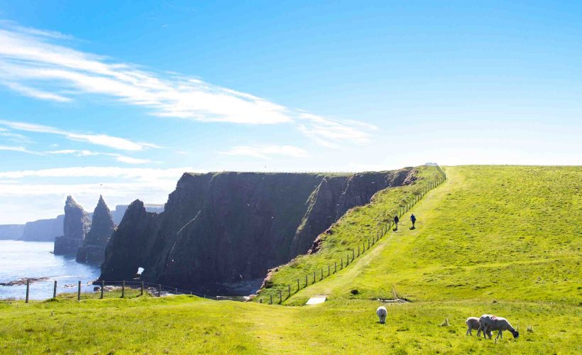 Two people walking along the Inverness Trail on the north coast of Scotland near John O'Groats