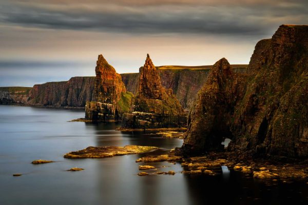 Panorama of Duncansby Head cliffs in sunset light,