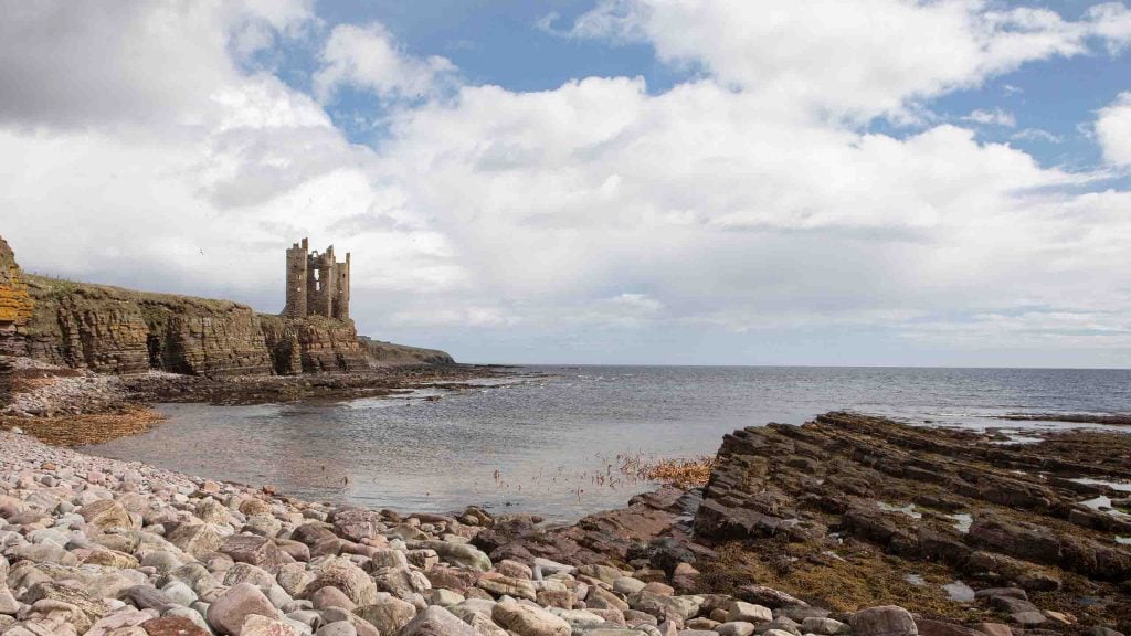 Keiss Beach with castle in background on a summers day