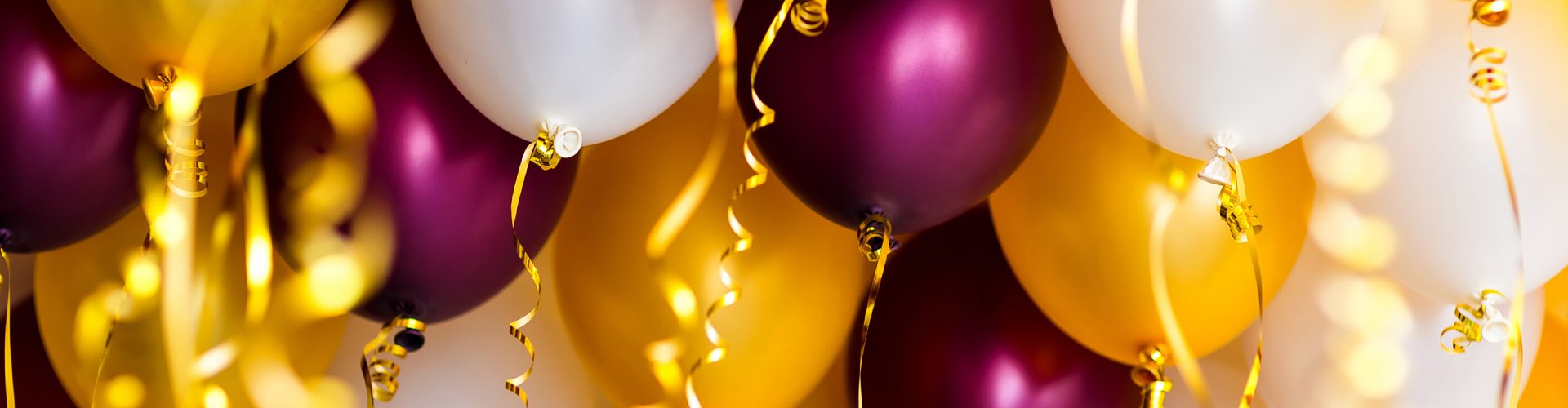 Purple, white and gold balloons at a party venue