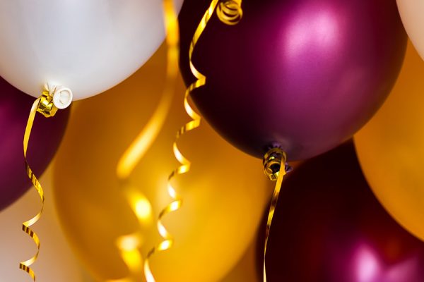 Purple, white and gold balloons at a party venue