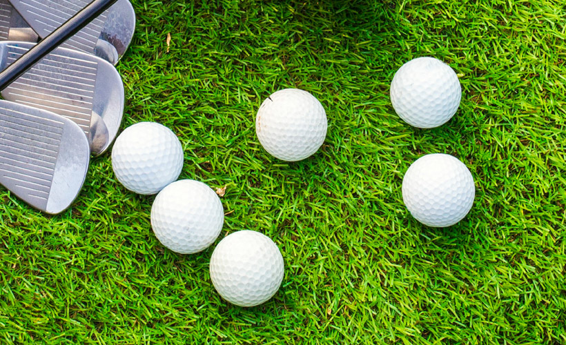 Golf balls lying on the grass