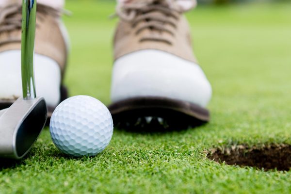 Golfer putting a ball on the golf course