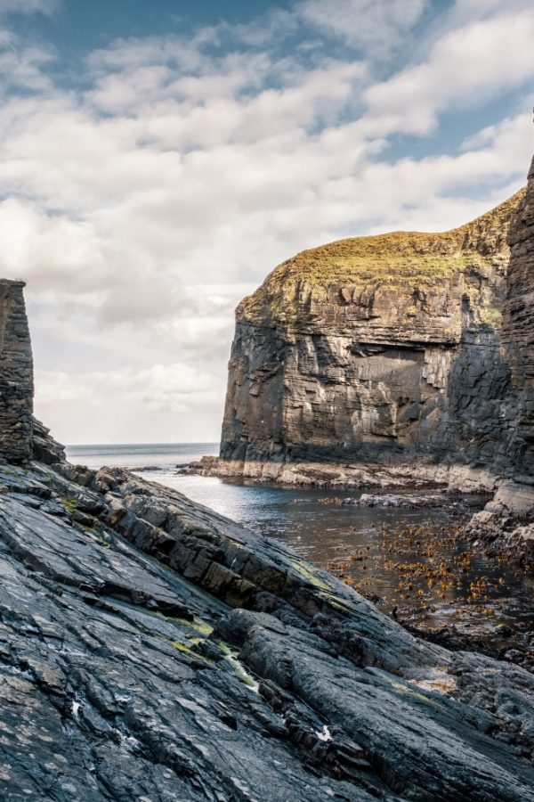 Steep cliffs and rocks protect the entrance to Whaligoe Harbour