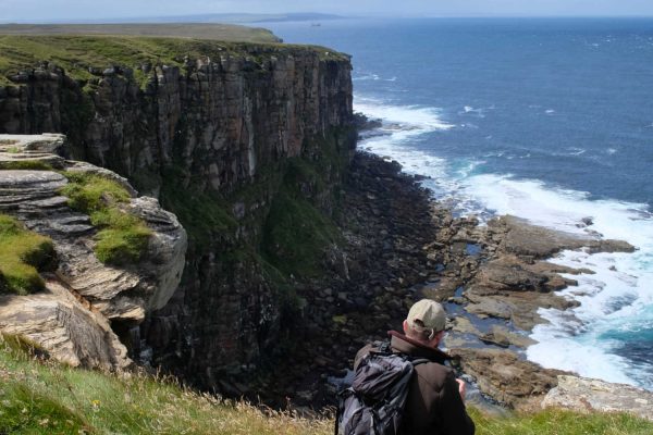 Man taking in the views from Dunnet Head in Scotland