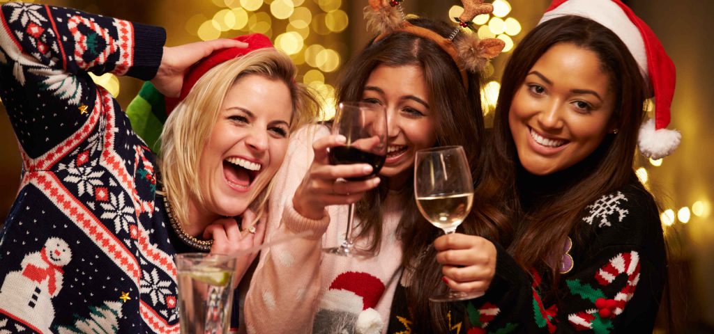 Three friends enjoying festive drinks together
