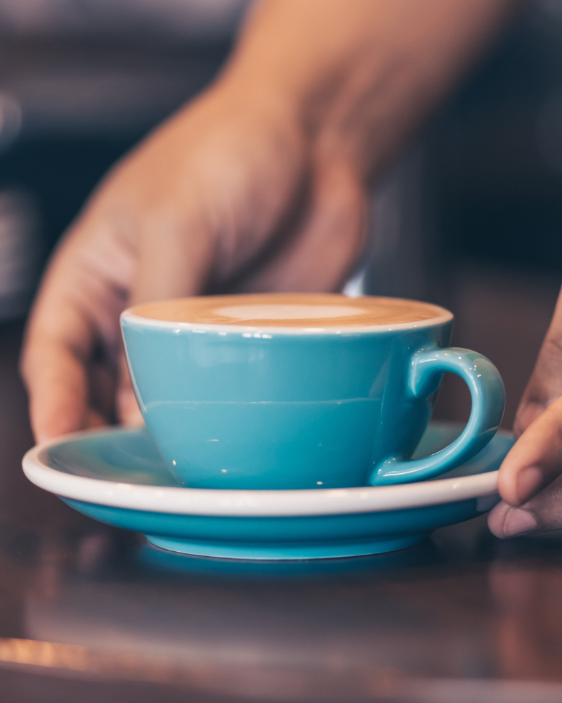 Serving a cup of coffee in a cafe