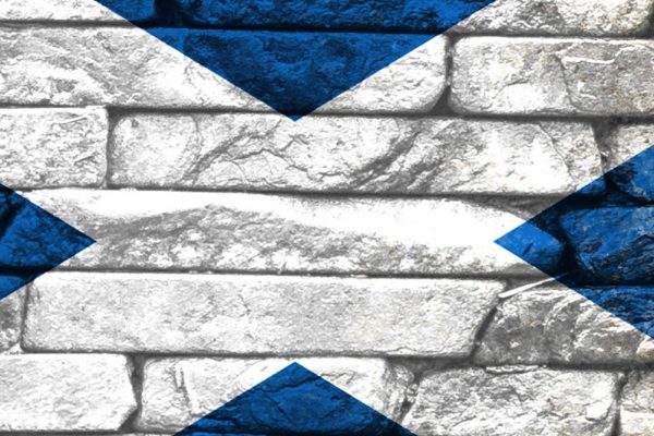 Saltire flag painted on a brick wall
