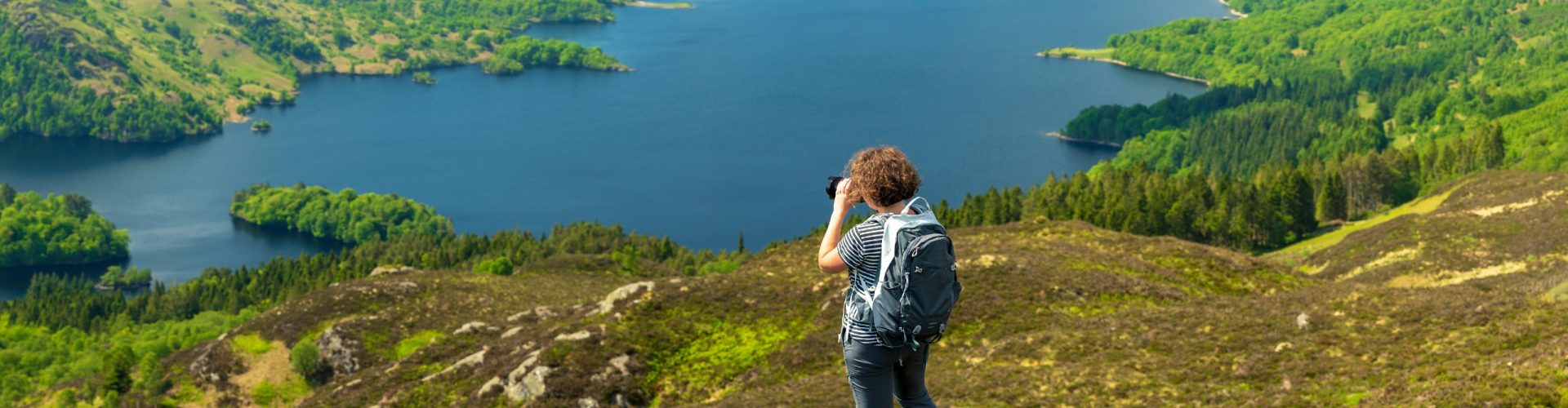 Woman taking photos in Scotland