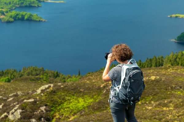 Woman taking photos in Scotland