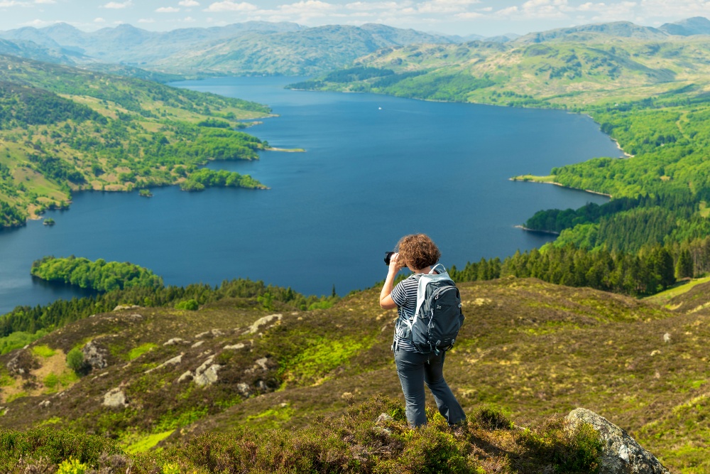 Woman with camera in countryside