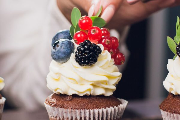 Cakes decorated with cream and berries