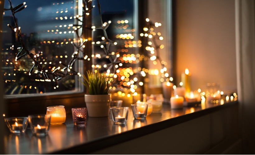 Tea lights and candles looking cosy on a windowsill