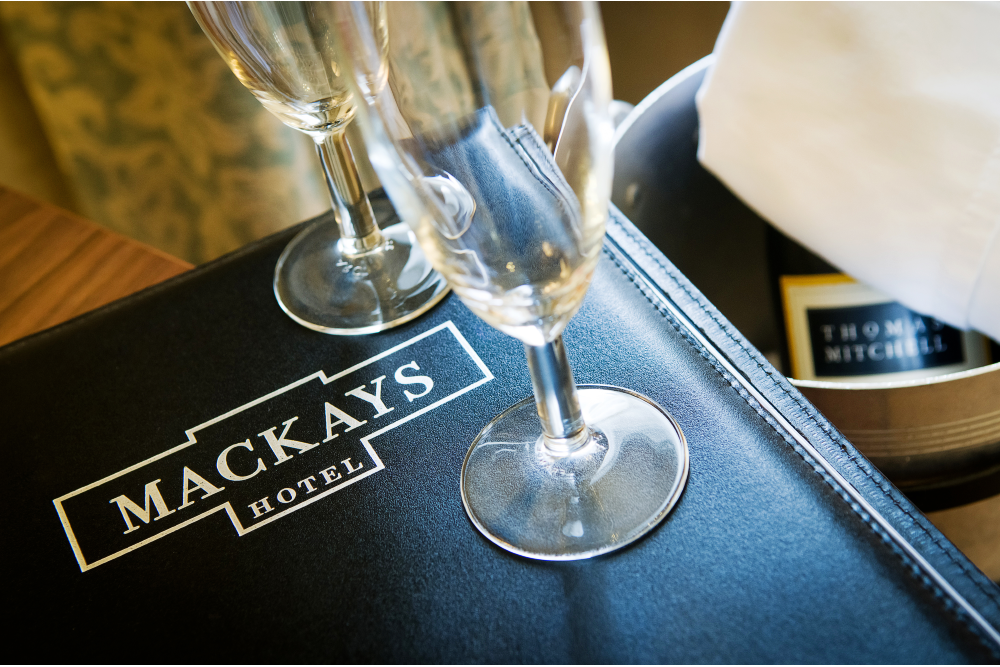 Photo of two glasses on a Mackays Hotel folder