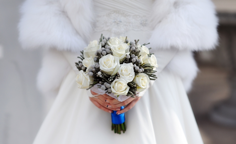 Closeup of bride hands holding beautiful wedding bouquet