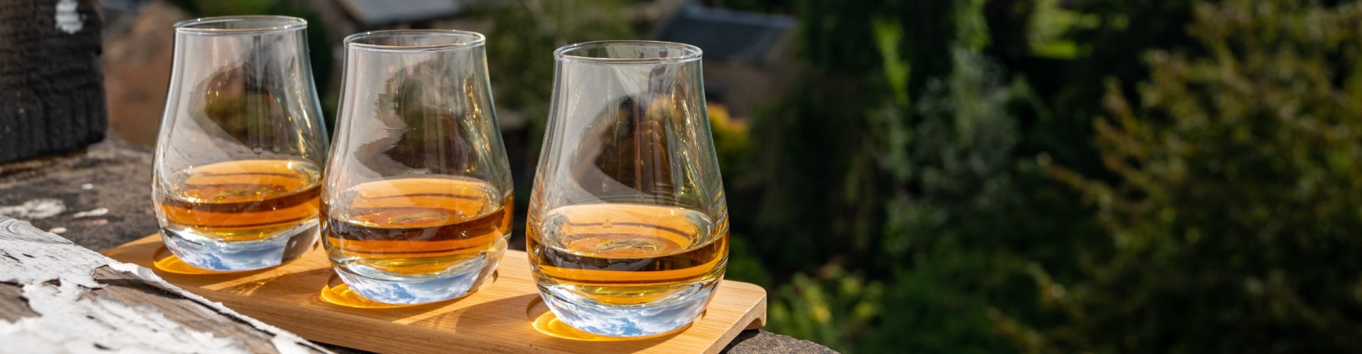 Three glasses of whisky on a window sill