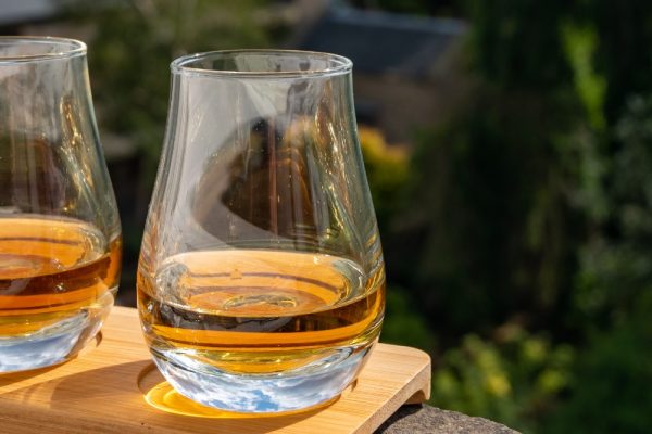 Three glasses of whisky on a window sill