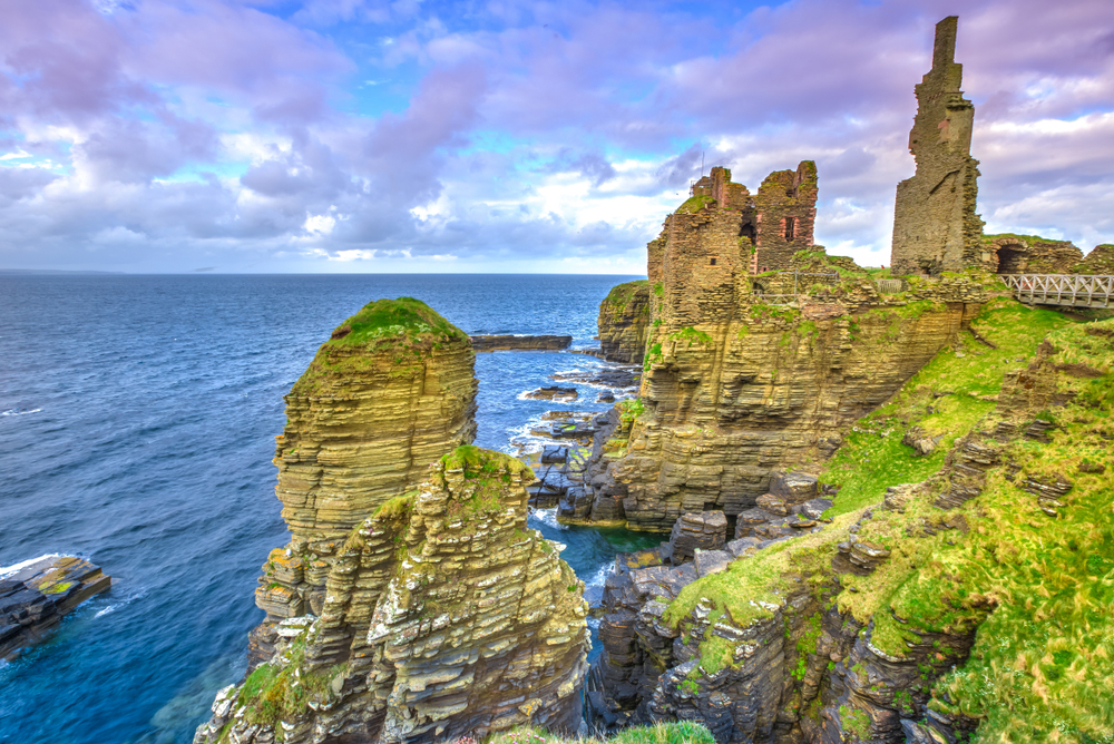 Castle Sinclair Girnigoe from Sinclair's Bay. The medieval and renaissance fortress is the most spectacular ruin in the North of Scotland, in the Highlands near Wick and Caithness. Sunset shot.