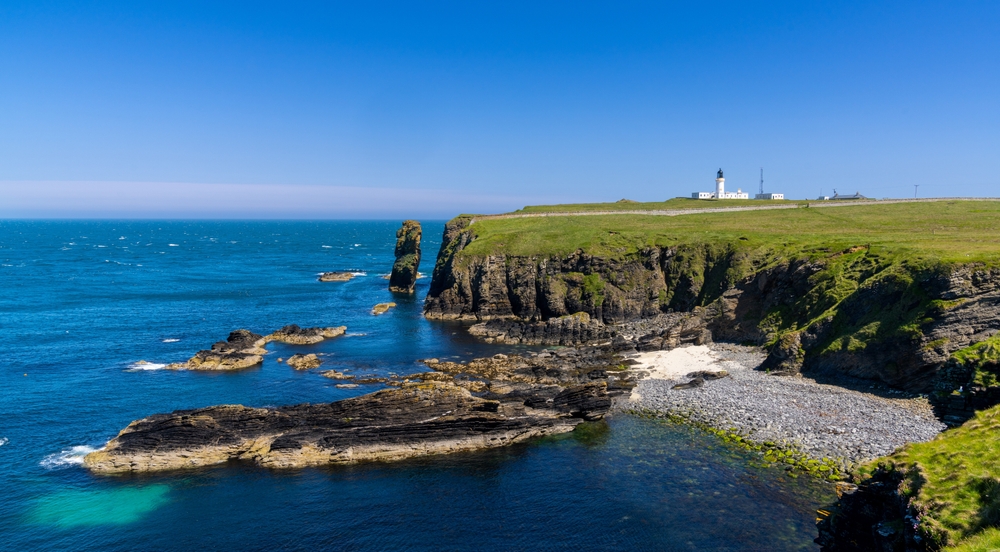 A panorama view of the wild Caithness coast and the Noss Head Lighthouse